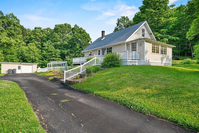 2031 Rte 302, Circleville, NY 10919 - view of front facade featuring a detached garage, an outbuilding, a chimney, a front lawn, and a shingled roof