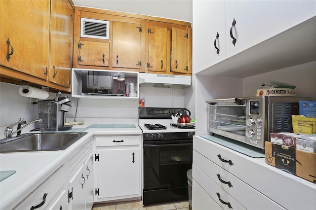 70-20 108th St Unit 5P, Forest Hills, NY 11375 - kitchen with range with gas stovetop, black microwave, under cabinet range hood, light countertops, and brown cabinetry