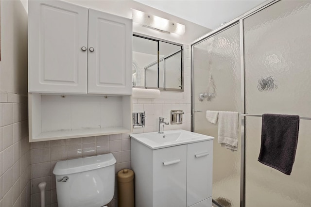 70-20 108th St Unit 5P, Forest Hills, NY 11375 - bathroom featuring tile walls, vanity, a shower stall, and decorative backsplash