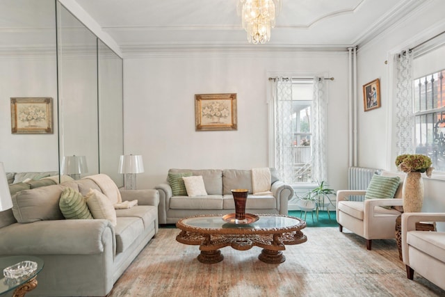 223 Warburton Ave, Yonkers, NY 10701 - living room featuring crown molding, plenty of natural light, radiator, wood finished floors, and a chandelier