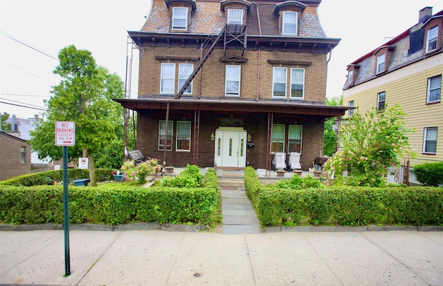 223 Warburton Ave, Yonkers, NY 10701 - victorian home with brick siding, mansard roof, and covered porch