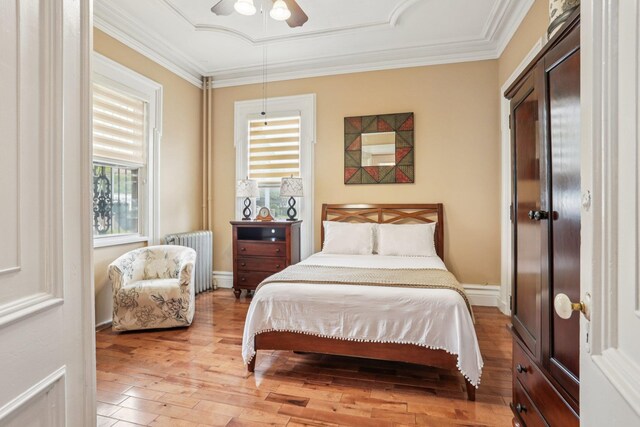 223 Warburton Ave, Yonkers, NY 10701 - bedroom featuring radiator heating unit, light wood-style flooring, ornamental molding, and a ceiling fan
