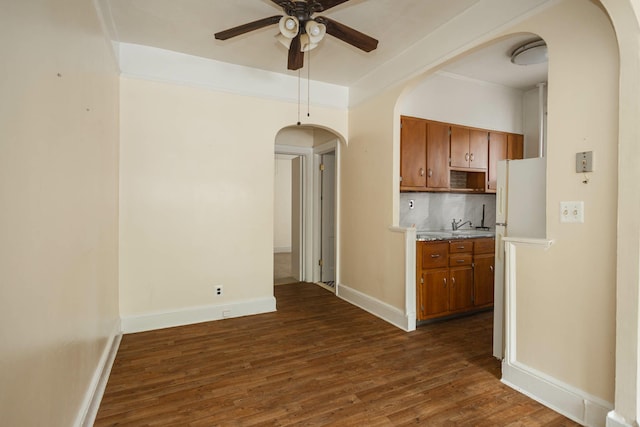 40-29 201st St Unit A, B, C, Bayside, NY 11361 - kitchen featuring arched walkways, brown cabinets, ceiling fan, light countertops, and dark wood-style floors
