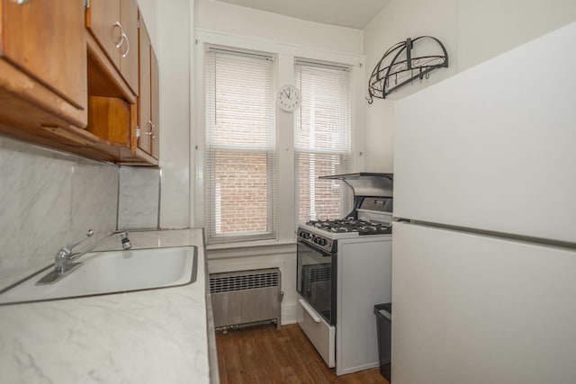 40-29 201st St Unit A, B, C, Bayside, NY 11361 - kitchen with white appliances, radiator heating unit, brown cabinets, and dark wood-type flooring