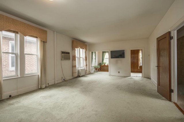 40-29 201st St Unit A, B, C, Bayside, NY 11361 - unfurnished living room featuring carpet floors, a wall unit AC, and radiator