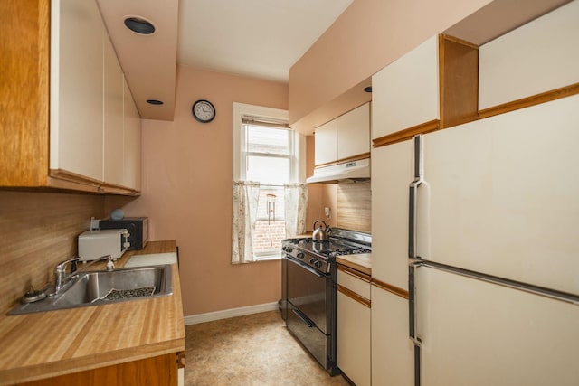 40-29 201st St Unit A, B, C, Bayside, NY 11361 - kitchen with freestanding refrigerator, black range with gas stovetop, under cabinet range hood, backsplash, and white cabinets