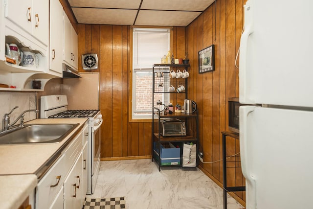 40-29 201st St Unit A, B, C, Bayside, NY 11361 - kitchen with white appliances, wooden walls, white cabinetry, light marble finish floors, and under cabinet range hood