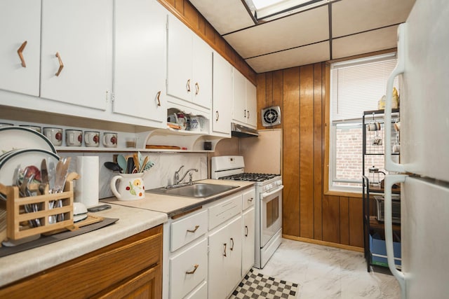 40-29 201st St Unit A, B, C, Bayside, NY 11361 - kitchen featuring white appliances, wood walls, light marble finish flooring, under cabinet range hood, and white cabinetry