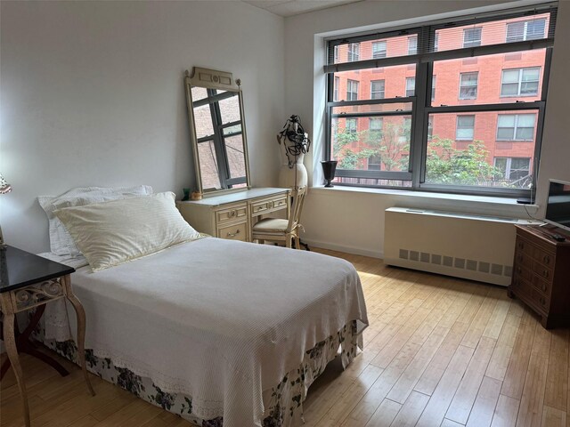 837 Washington Ave Unit 3A, Bronx, NY 10451 - bedroom with radiator heating unit and wood finished floors