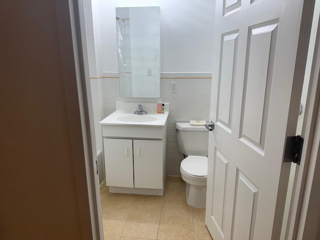 837 Washington Ave Unit 3A, Bronx, NY 10451 - bathroom with vanity, tile patterned floors, wainscoting, and tile walls