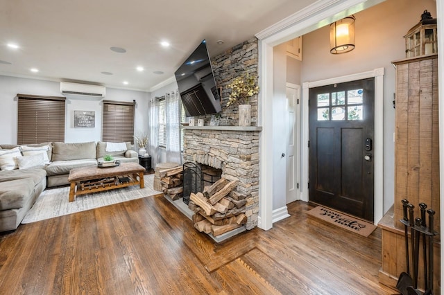 35 Irenhyl Ave, Port Chester, NY 10573 - living area featuring an AC wall unit, wood finished floors, and a stone fireplace