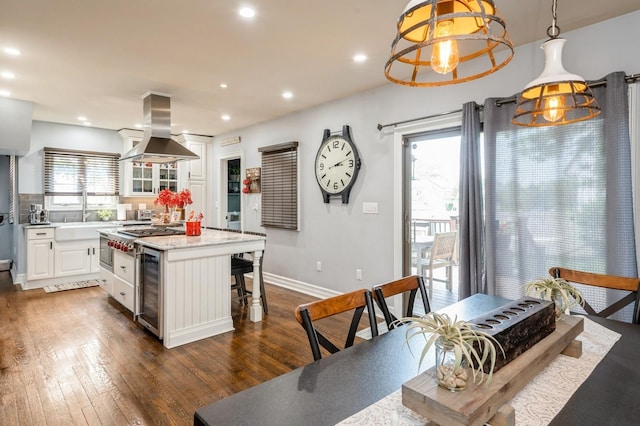 35 Irenhyl Ave, Port Chester, NY 10573 - kitchen with island range hood, white cabinetry, a kitchen breakfast bar, dark wood-type flooring, and beverage cooler