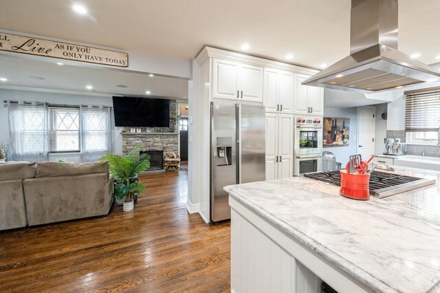 35 Irenhyl Ave, Port Chester, NY 10573 - kitchen with stainless steel appliances, island range hood, open floor plan, a fireplace, and recessed lighting