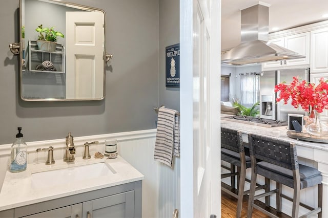 35 Irenhyl Ave, Port Chester, NY 10573 - bathroom with a wainscoted wall, vanity, and wood finished floors
