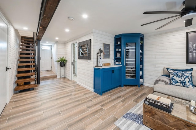 35 Irenhyl Ave, Port Chester, NY 10573 - living room featuring wooden walls, ceiling fan, stairs, light wood-style flooring, and recessed lighting