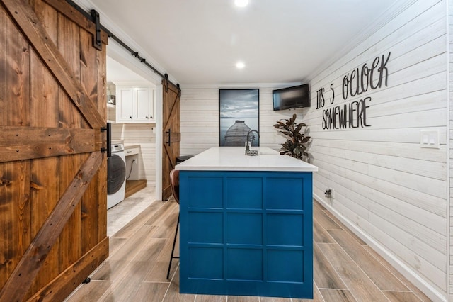 35 Irenhyl Ave, Port Chester, NY 10573 - misc room featuring a barn door, wood tiled floors, wood walls, washer / clothes dryer, and recessed lighting