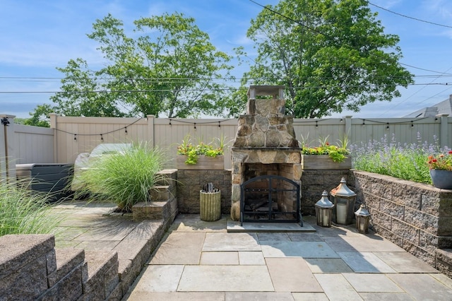35 Irenhyl Ave, Port Chester, NY 10573 - fenced backyard featuring an outdoor stone fireplace and a patio