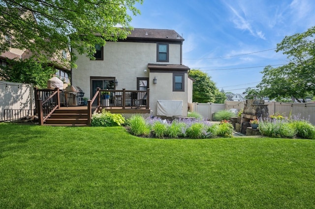 35 Irenhyl Ave, Port Chester, NY 10573 - rear view of house featuring stucco siding, a wooden deck, and a fenced backyard