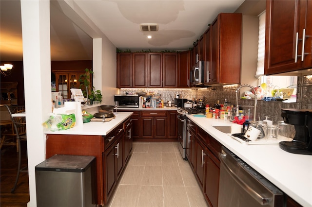 3344 Giles Pl, Bronx, NY 10463 - kitchen featuring stainless steel appliances, light countertops, tasteful backsplash, and light tile patterned floors