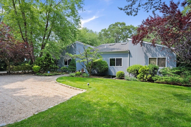 41 Park Cir, Quogue, NY 11959 - rear view of property with a yard and dirt driveway