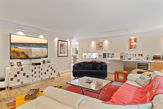41 Park Cir, Quogue, NY 11959 - living room with beverage cooler, attic access, and wood finished floors