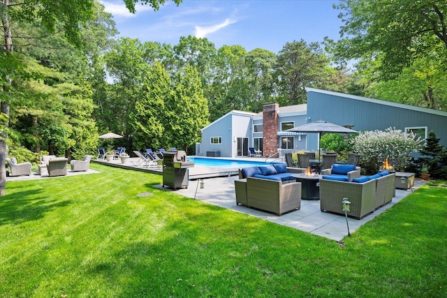 41 Park Cir, Quogue, NY 11959 - swimming pool featuring an outdoor living space with a fire pit, a lawn, a patio area, and a grill