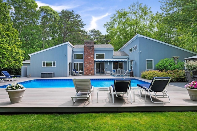 41 Park Cir, Quogue, NY 11959 - outdoor pool with a wooden deck, a lawn, and a jacuzzi