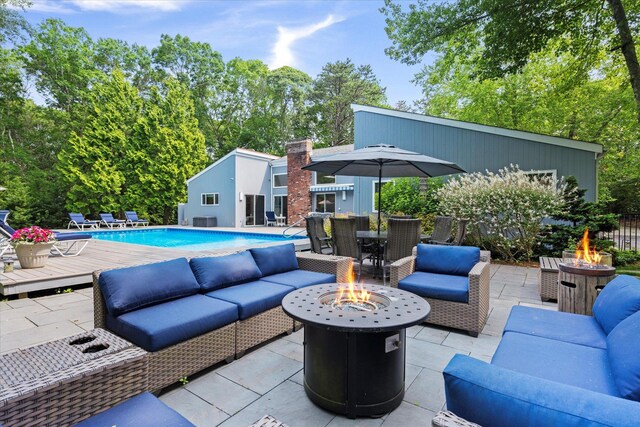 41 Park Cir, Quogue, NY 11959 - view of patio / terrace featuring an outdoor living space with a fire pit, an outdoor pool, and outdoor dining area