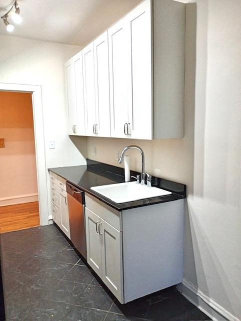41-42 42nd St Unit 4L, Sunnyside, NY 11104 - kitchen featuring stainless steel dishwasher, dark countertops, and white cabinets