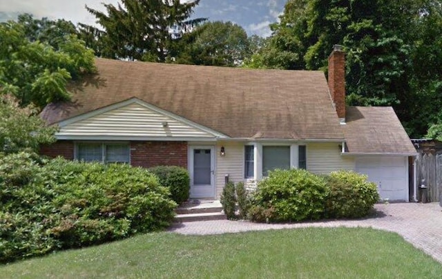 68 Hillwood Dr, Huntington Station, NY 11746 - view of front of house featuring a garage, a chimney, driveway, and a front yard