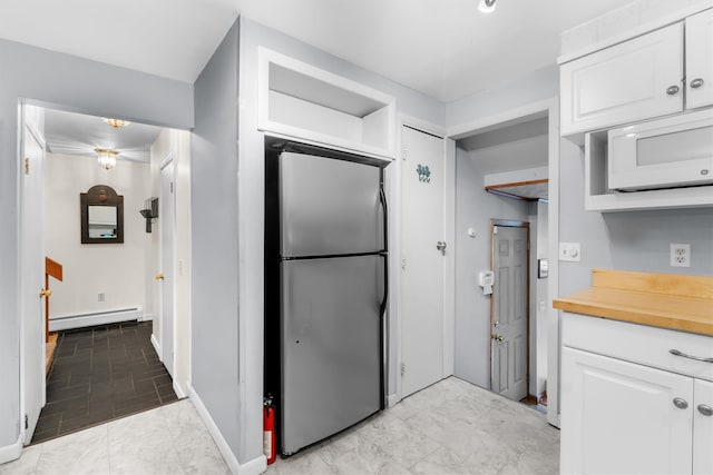 5 Rose Ests Unit 2, Walden, NY 12586 - kitchen with freestanding refrigerator, a baseboard radiator, white microwave, and white cabinets