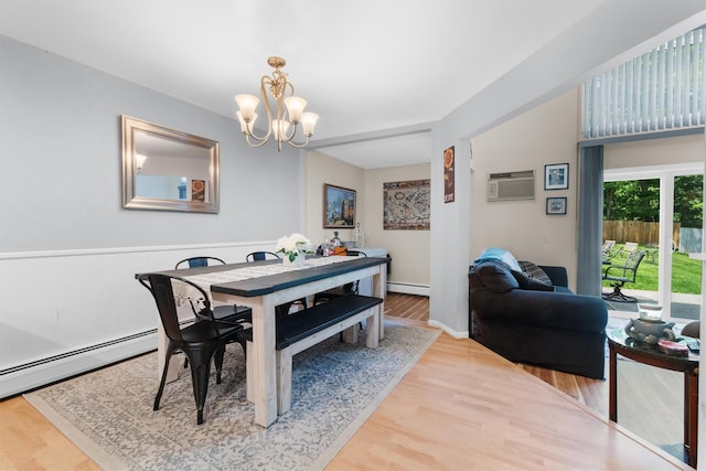 5 Rose Ests Unit 2, Walden, NY 12586 - dining area featuring a chandelier, a wall mounted AC, wood finished floors, and a baseboard radiator