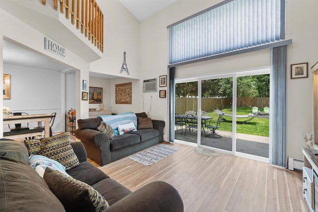 5 Rose Ests Unit 2, Walden, NY 12586 - living room with a towering ceiling, a baseboard radiator, wood finished floors, and a wall mounted air conditioner