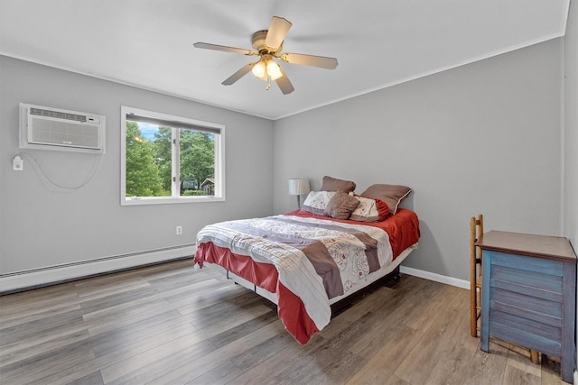 5 Rose Ests Unit 2, Walden, NY 12586 - bedroom with baseboard heating, a wall unit AC, wood finished floors, and ceiling fan
