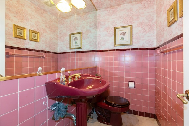 1 Ravine Rd, Great Neck, NY 11023 - bathroom with wallpapered walls, tile walls, a wainscoted wall, and tile patterned flooring