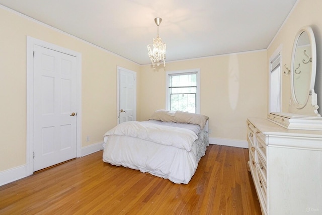1 Ravine Rd, Great Neck, NY 11023 - bedroom featuring light wood finished floors, a chandelier, and crown molding