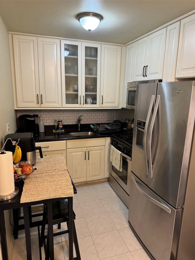 3121 Middletown Rd Unit 7G, Bronx, NY 10461 - kitchen featuring stainless steel appliances, decorative backsplash, white cabinetry, and glass insert cabinets