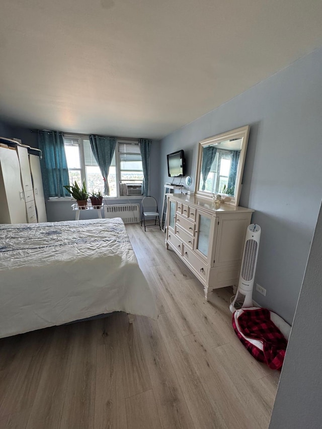 3121 Middletown Rd Unit 7G, Bronx, NY 10461 - bedroom with multiple windows, light wood finished floors, radiator, and cooling unit