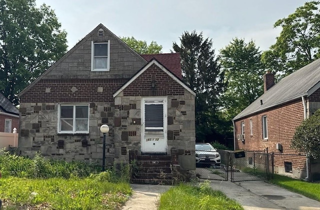 183-12 Elmira Ave, Saint Albans, NY 11412 - view of front of house featuring stone siding, a gate, and entry steps