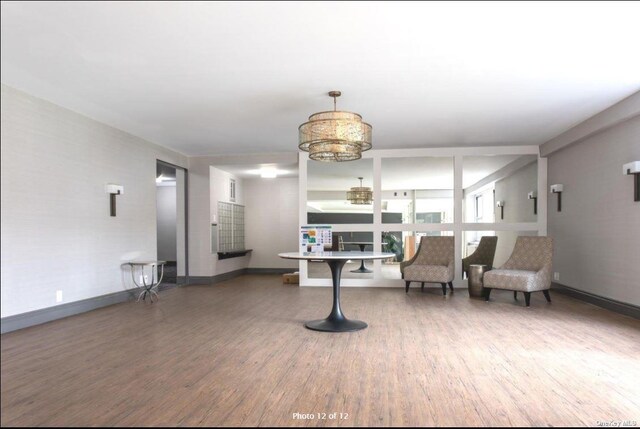 125 Main St Unit 2H, Port Washington, NY 11050 - sitting room featuring wood finished floors and a chandelier