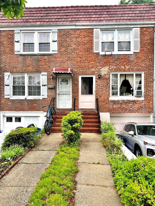 4328 195th St, Flushing, NY 11358 - view of property with brick siding, entry steps, and a shingled roof