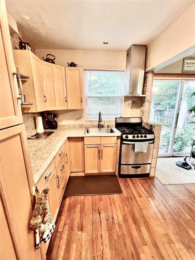 4328 195th St, Flushing, NY 11358 - kitchen featuring stainless steel gas stove, wall chimney exhaust hood, light brown cabinets, plenty of natural light, and recessed lighting