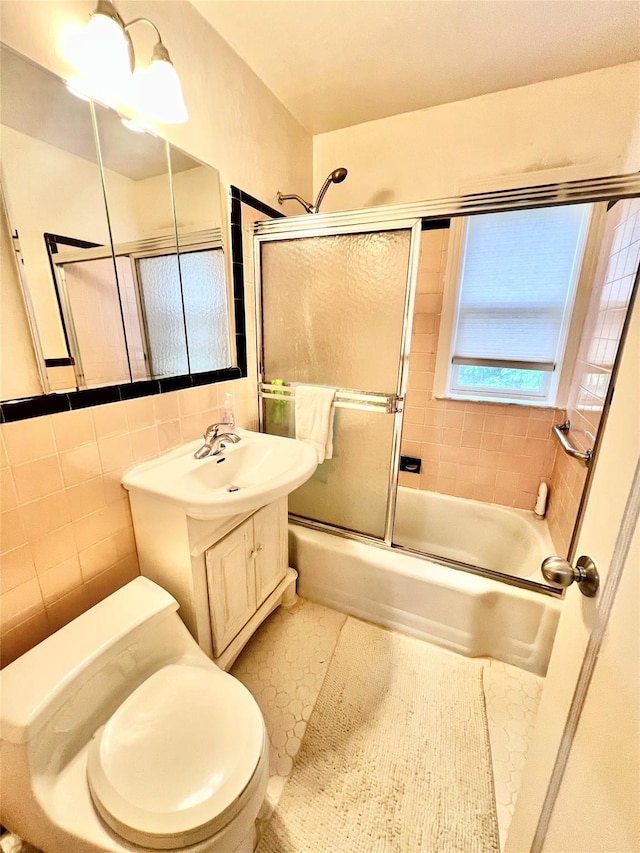 4328 195th St, Flushing, NY 11358 - full bath featuring tile walls, combined bath / shower with glass door, vanity, and tile patterned flooring