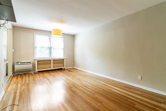 325 Palmer Ter Unit 1D, Mamaroneck, NY 10543 - unfurnished room with radiator and hardwood / wood-style flooring