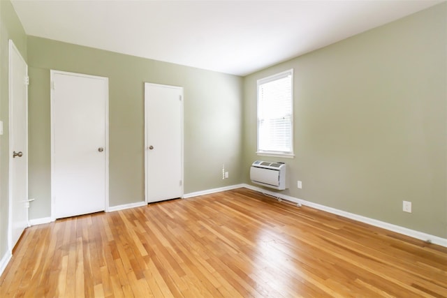 325 Palmer Ter Unit 1D, Mamaroneck, NY 10543 - unfurnished bedroom with light wood-style floors and an AC wall unit