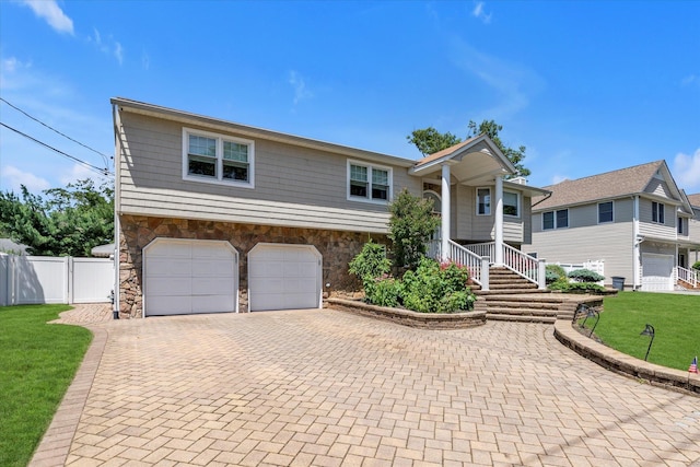 2080 Beech St, Wantagh, NY 11793 - split foyer home featuring stone siding, decorative driveway, and an attached garage