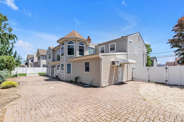 2080 Beech St, Wantagh, NY 11793 - rear view of house featuring a gate, a patio area, and a wall mounted AC