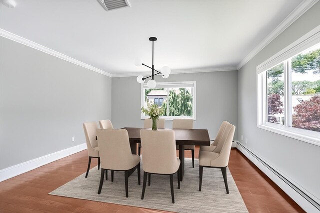 2080 Beech St, Wantagh, NY 11793 - dining room featuring baseboard heating, plenty of natural light, wood finished floors, a chandelier, and ornamental molding