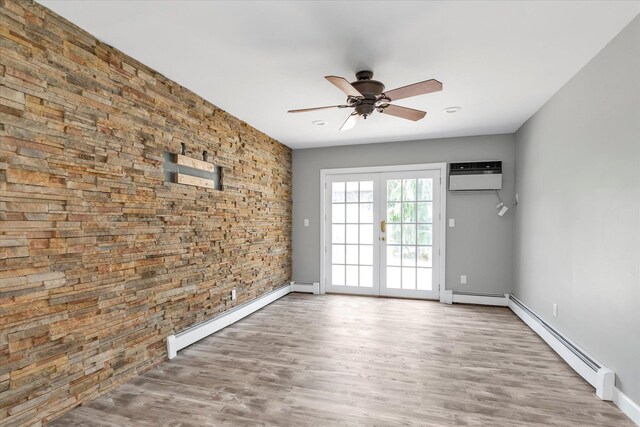 2080 Beech St, Wantagh, NY 11793 - empty room featuring baseboard heating, a ceiling fan, an AC wall unit, and wood finished floors