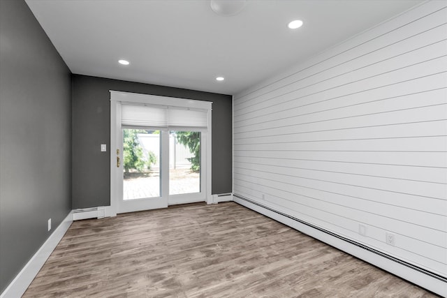2080 Beech St, Wantagh, NY 11793 - empty room featuring baseboard heating, recessed lighting, and wood finished floors